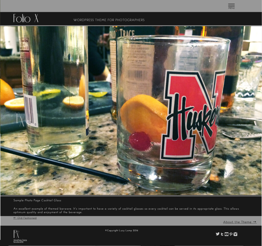 Close up image of bar glasses on marble counter.